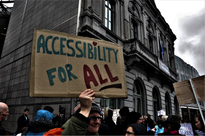 Man Holding a sign with the inscription "Accessibility for all"